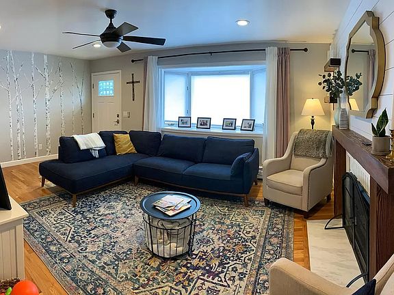 Living room, bay window (top down shades), and LED fireplace