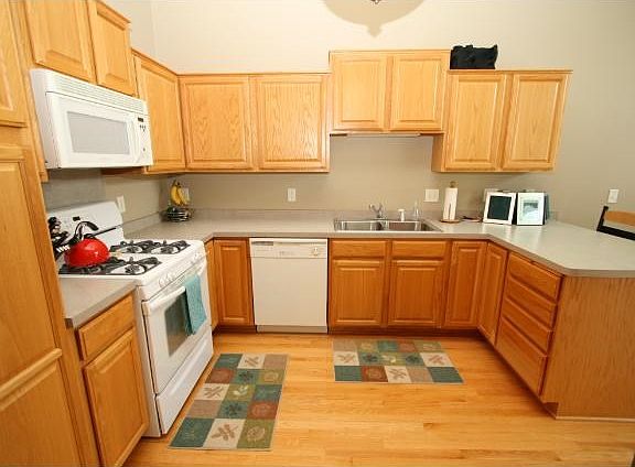 Beautiful kitchen with hardwood floors and abundance of cabinet space.