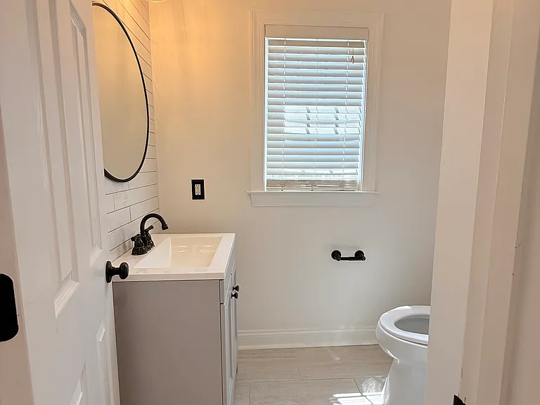 stunning half bathroom off of kitchen area.
