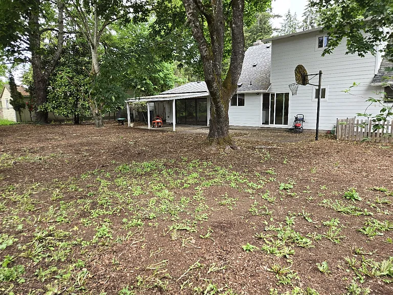 Huge backyard with basketball hoop over patio