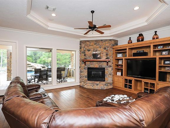 Large family room with built ins and floor to ceiling stone fireplace! Cove lighting in ceiling!