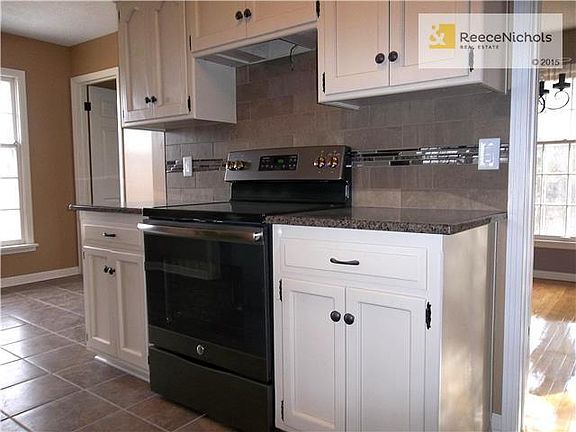 Kitchen with new Ceramic Tile Floor, Electric Range and Refrigerator.