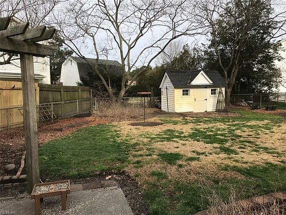 Large, fenced backyard with cute storage shed