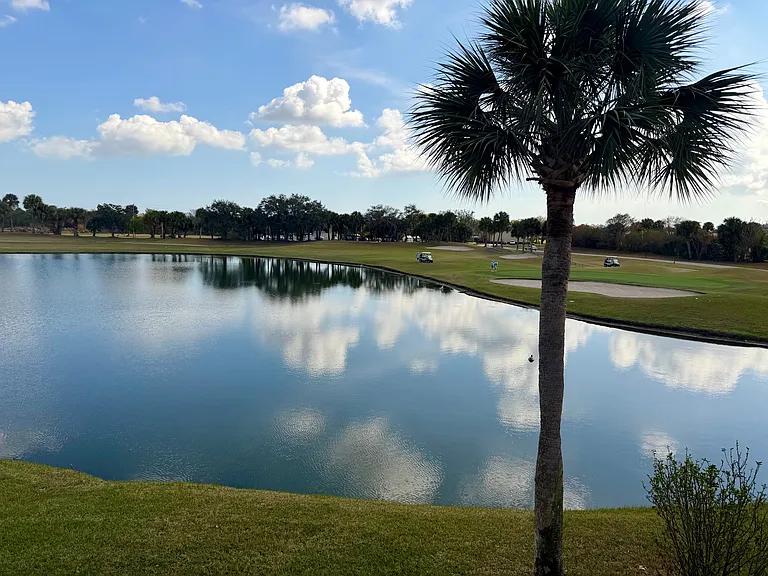 Enjoy STUNNING lake & golf course views from the Living Room!