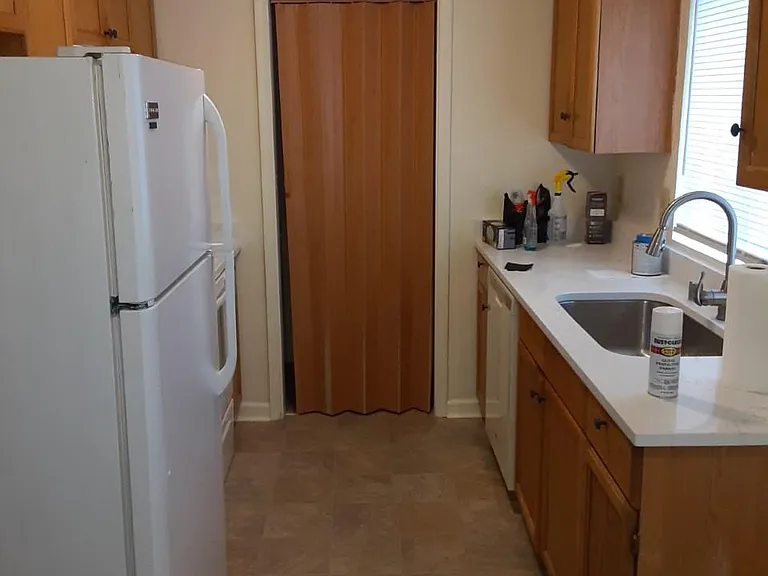 Kitchen, washer and dryer behind folding door on end of kitchen.