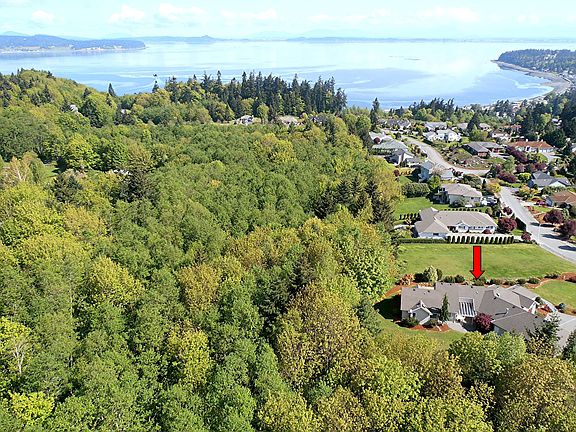 California-style rambler sits high on the hill with commanding Sound/Mtn views