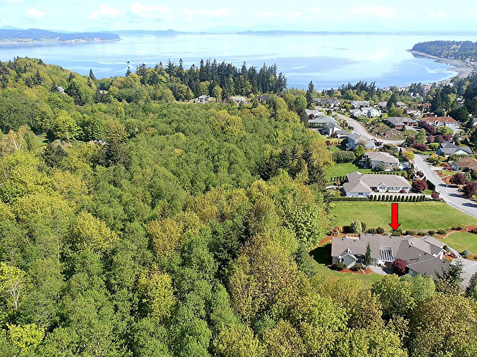 California-style rambler sits high on the hill with commanding Sound/Mtn views