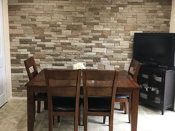 Dinning area - Accent brick wall - Tile floor