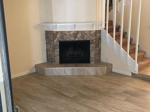 Living room looking at fire place and stairs to 2nd floor