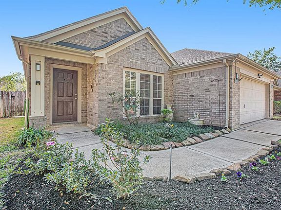 A curved walkway leads you past flowerbeds with blooming foliage!