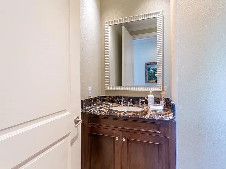 Powder Room boasts Imperial Brown marble counters & Crema Marfil inlaid floor.