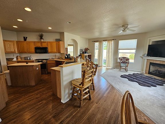 Kitchen, Island, Hardwood Floors open to Dining Room and family Room. Gas Fireplace in Dining Room