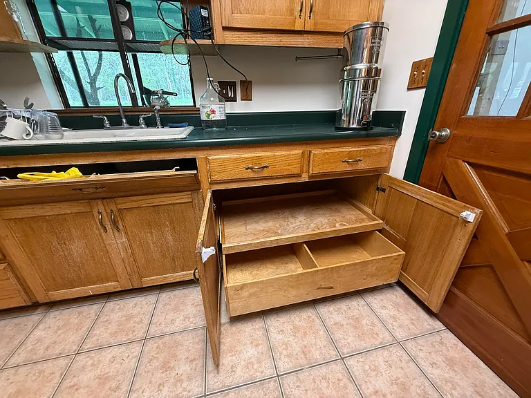 All of the lower shelves pull out. There's a small drawer in front of the sink.