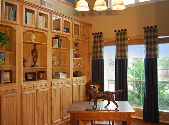 Worthy of the cover of Architectural Digest, the 2-story Study offers both form and function.  The exquisitely crafted bookcase is matched by the designer 'laminate' plank floors, tasteful window coverings, unique light fixture and vista views