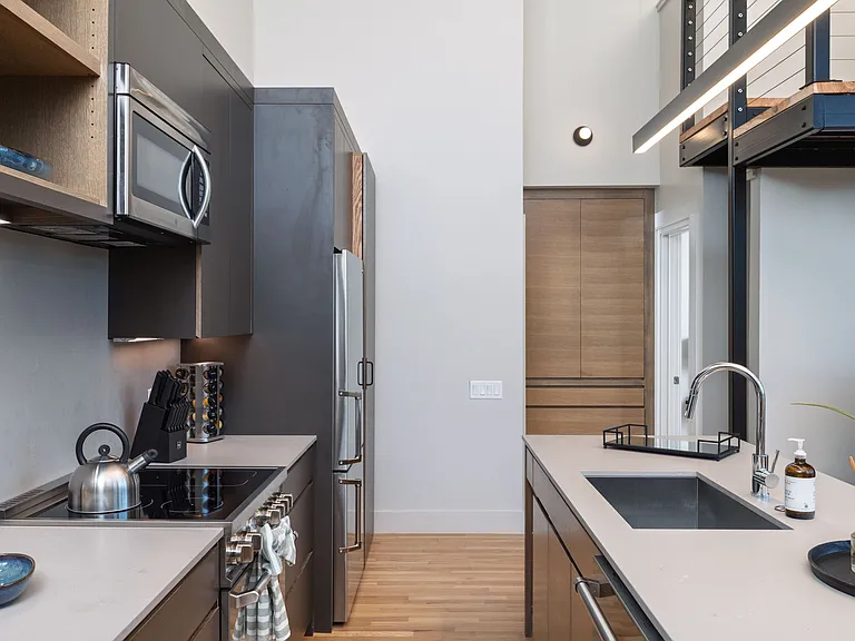 Open concept kitchen with seating for 4 at the kitchen island. The kitchen is fully stocked and ready to use.