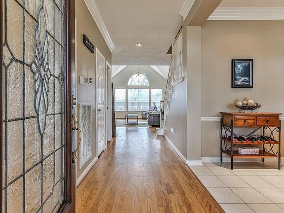 Bright entryway with abundant natural light and hardwood floors