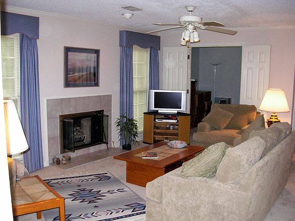 Fireplace with windows on either side providing plenty of light into family rm