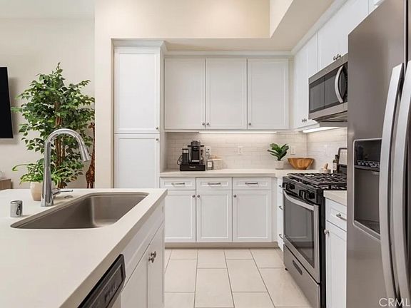 Bright kitchen with a sitting bar is perfect for working, meals or hanging out.
