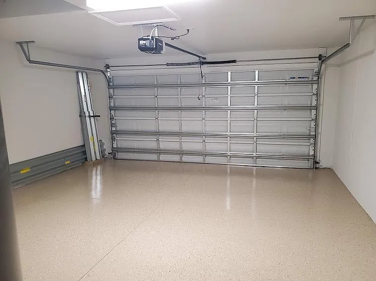 pristine garage with apoxy flooring, hurricane shudders provided
