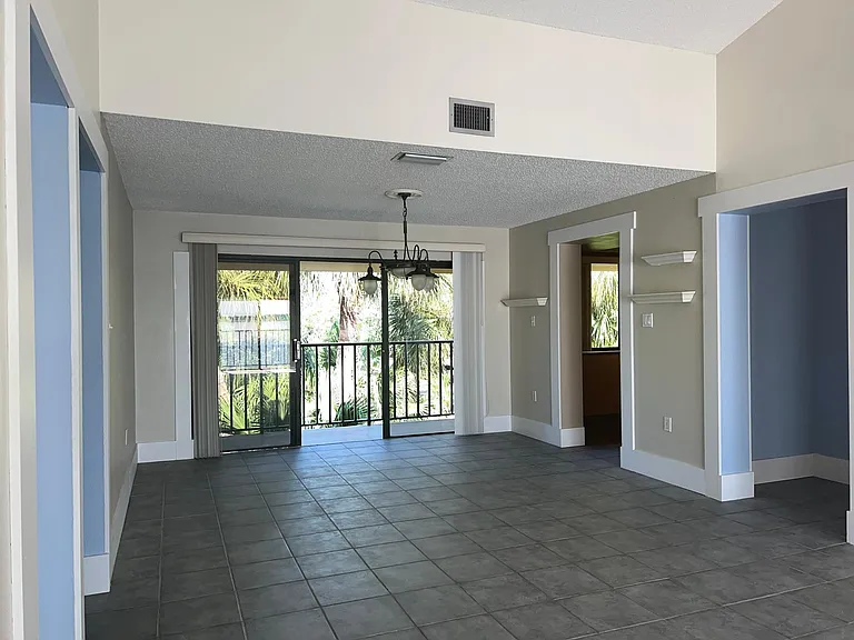Dining room with sliding door opening to 2nd balcony overlooking pond (facing west)