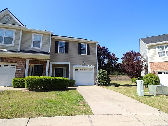 Front of the townhouse. Single driveway and garage.
