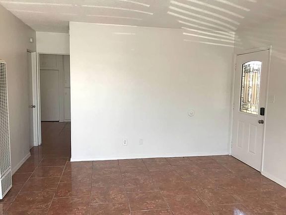 Entryway to Living room. Hallway to bedrooms and bath