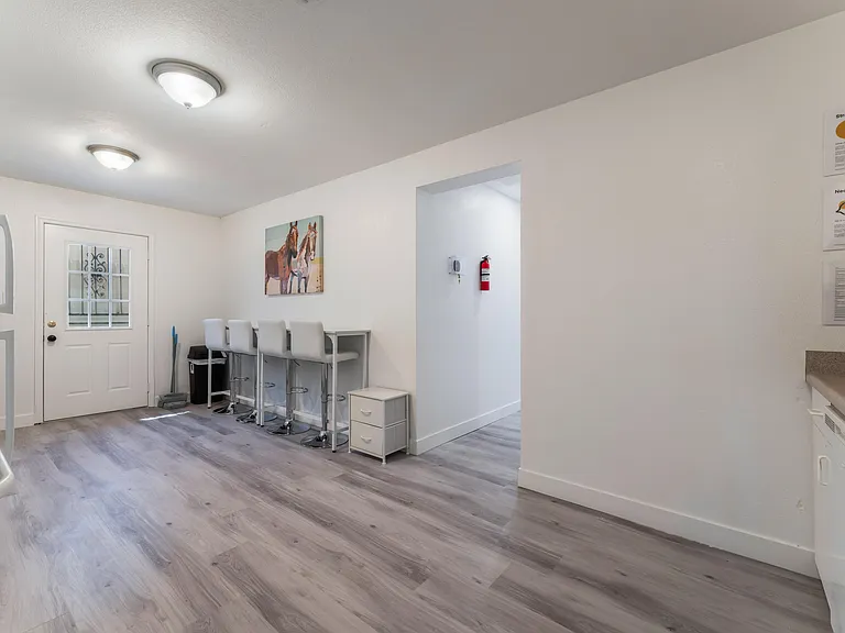 Kitchen features stylish bartop with inviting bar seats, perfect for casual dining and socializing.