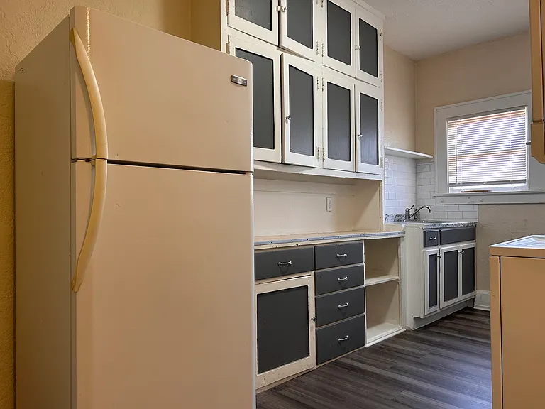 Kitchen looking at the cabinet space, sink and refrigerator