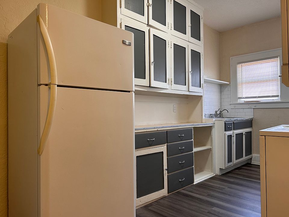 Kitchen looking at the cabinet space, sink and refrigerator