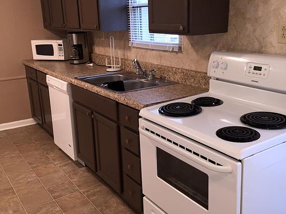 Home has stove, fridge, dishwasher and counter top microwave