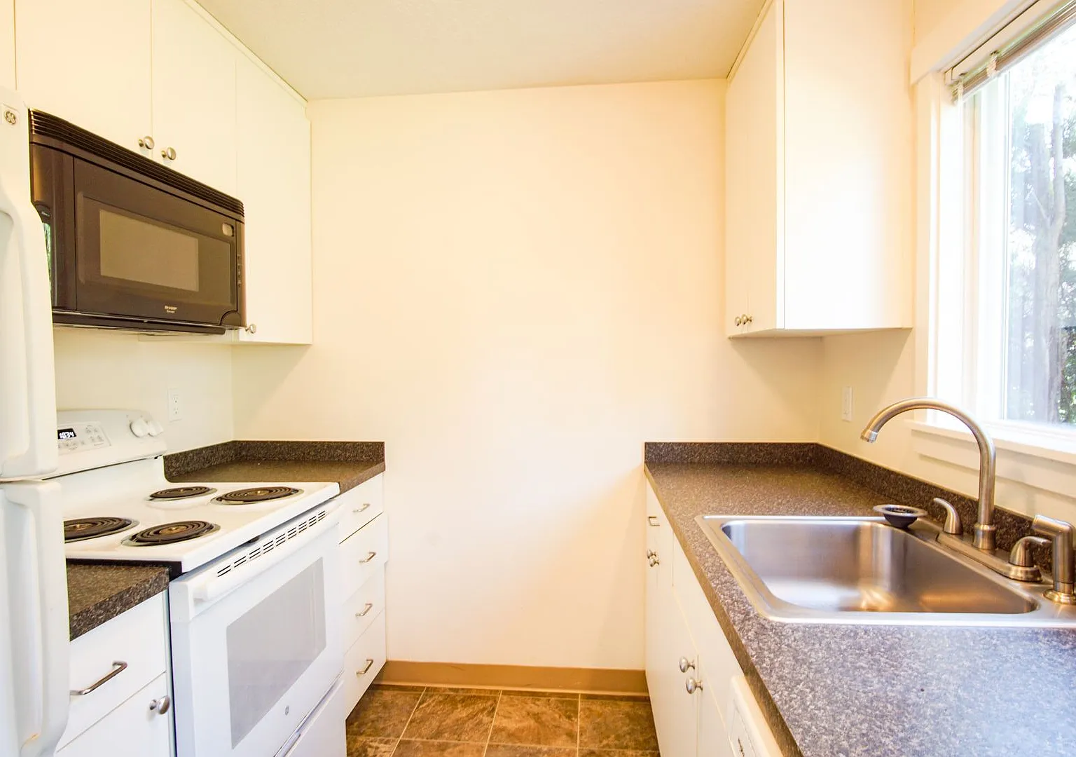 Spacious Corner Townhome with Private Patio + Parking! — Photo 1