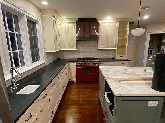 Commerical range and hood with granite and marble countertops