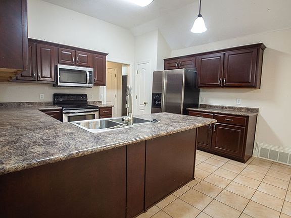 Kitchen with range, microwave and fridge