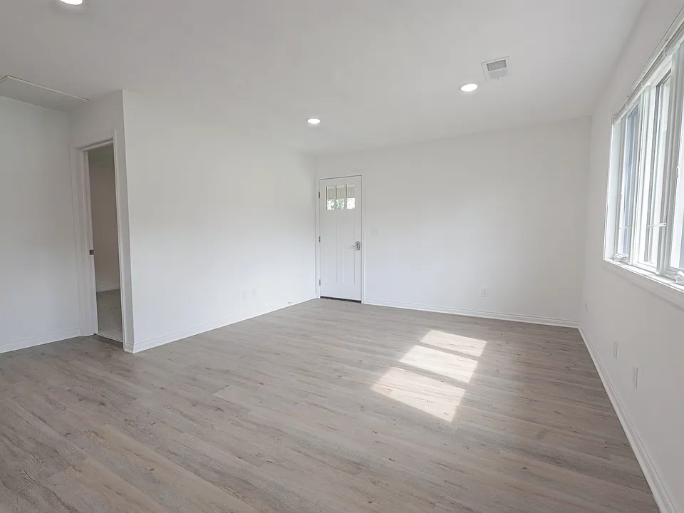 Living Room after entering front door. The other door with windows shown leads to the carport area