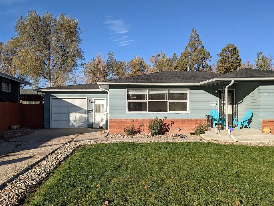 Street view from house. Basement apartment entry white door near driveway.