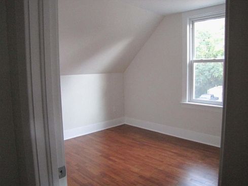 One of the upstairs bedrooms with plenty of natural light and Southern exposure.