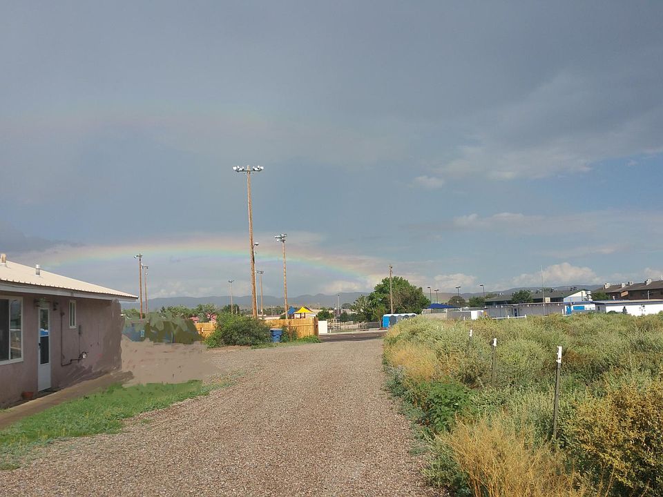 Exterior (stucco and metal roof) & Driveway (gravel); house
