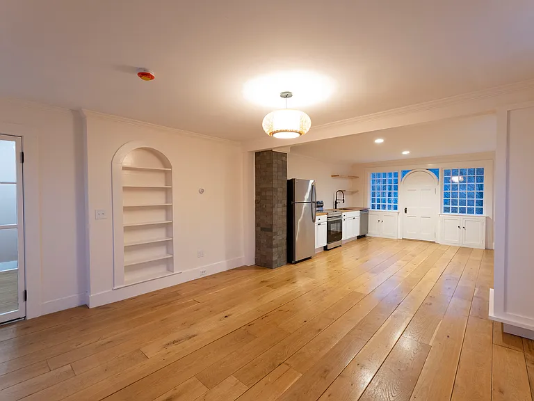 Historic detailing include built-ins and a wonderful window and door into the back garden.