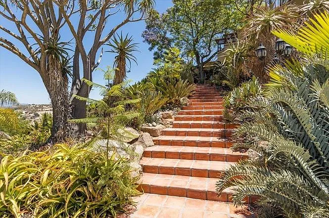 Saltillo tile steps lead from the guest driveway to the house
