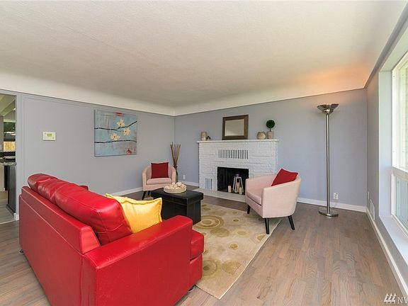 Mainfloor front room with great architectural treatments. It overlooks the front yard with a wall of brand new windows and trim. Refinished original hardwoods right up the breakfast nook/kitchen area, with direct access to the large backyard and shop/studio/storage.