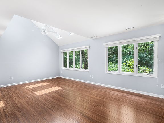 Living Room with Skylights 
wooded view
new wood floors