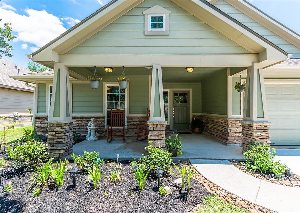 This craftsman home invites you in with the column based front porch, landscaping and solar lighting.