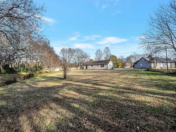 3/4 acre level lot.
This picture depicts the winter season of dormant grass. 
Gardener is included