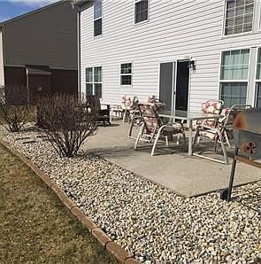 Exterior Rear - Large Patio with added landscaping rock and bushes