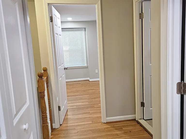 Upper level hallway with 3 beds and upstairs fully renovated bathroom