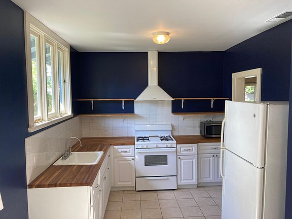 Large kitchen with gas range and butcher block countertops