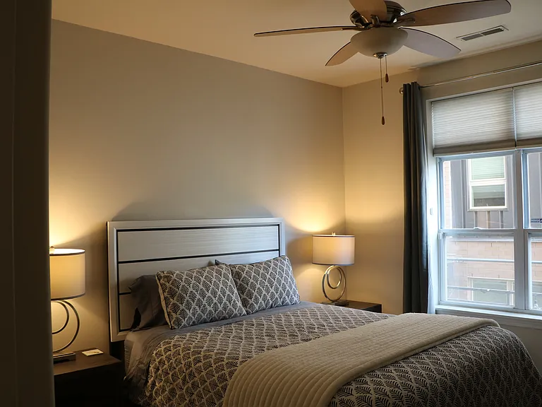 Second bedroom with a large window that fills the room with sunshine