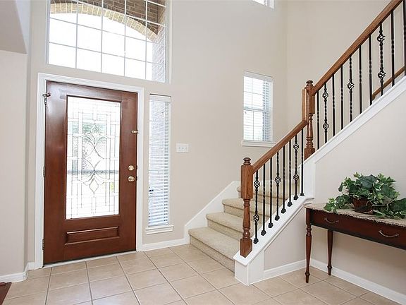 This view shows the entrance with all it's natural light coming through from both levels of the home.