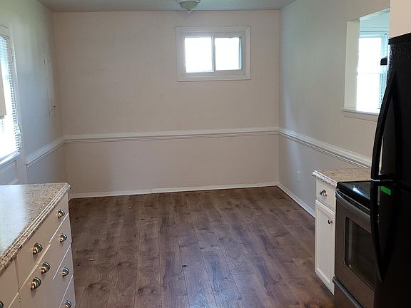 Large dining area in kitchen. "Pass through" opening to livi