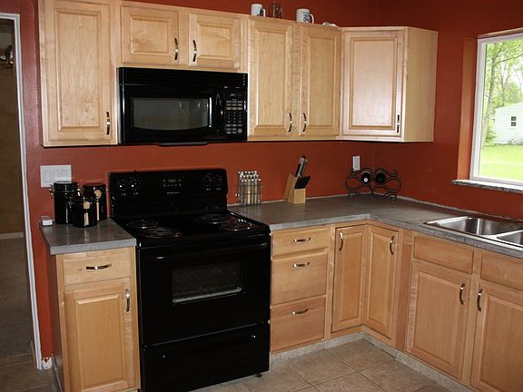 Beautiful maple cabinets in large kitchen with unique concrete counter tops